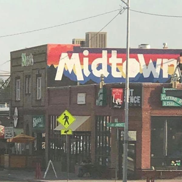Colorful "Midtown" mural on a building housing "Shear's" and "Curry House" restaurants.