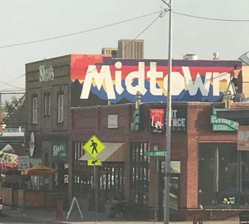 Colorful "Midtown" mural on a building housing "Shear's" and "Curry House" restaurants.