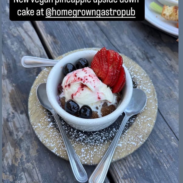 Homegrown Gastropub's vegan pineapple upside-down cake with ice cream, berries, and powdered sugar.