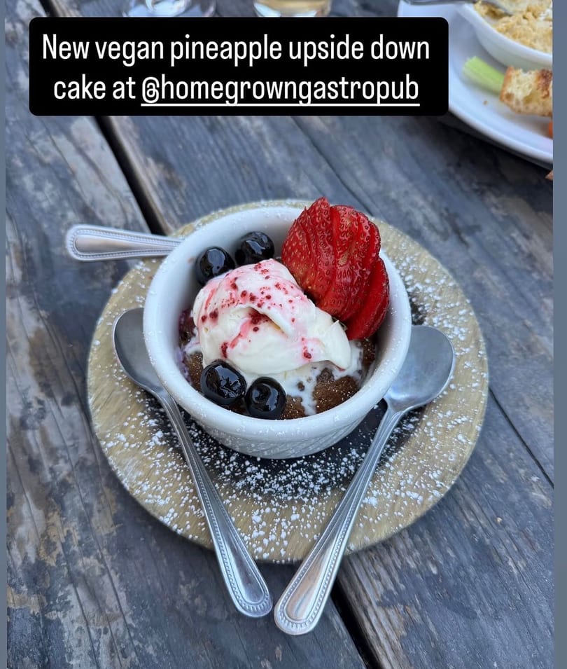 Homegrown Gastropub's vegan pineapple upside-down cake with ice cream, berries, and powdered sugar.